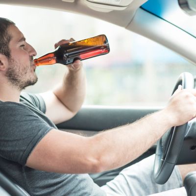 man-drinking-beer-car